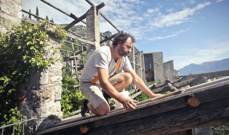 man repairing his roof