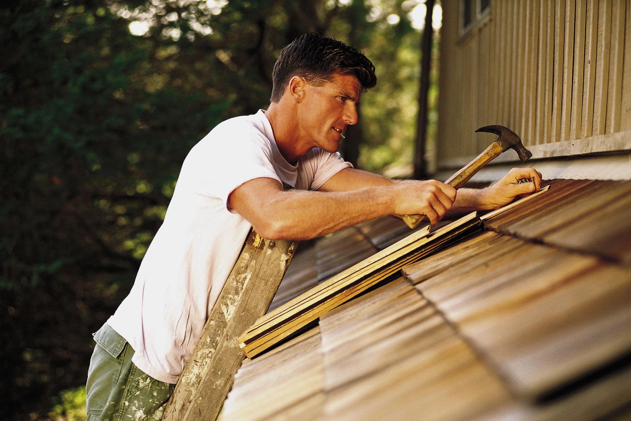 man patching roof