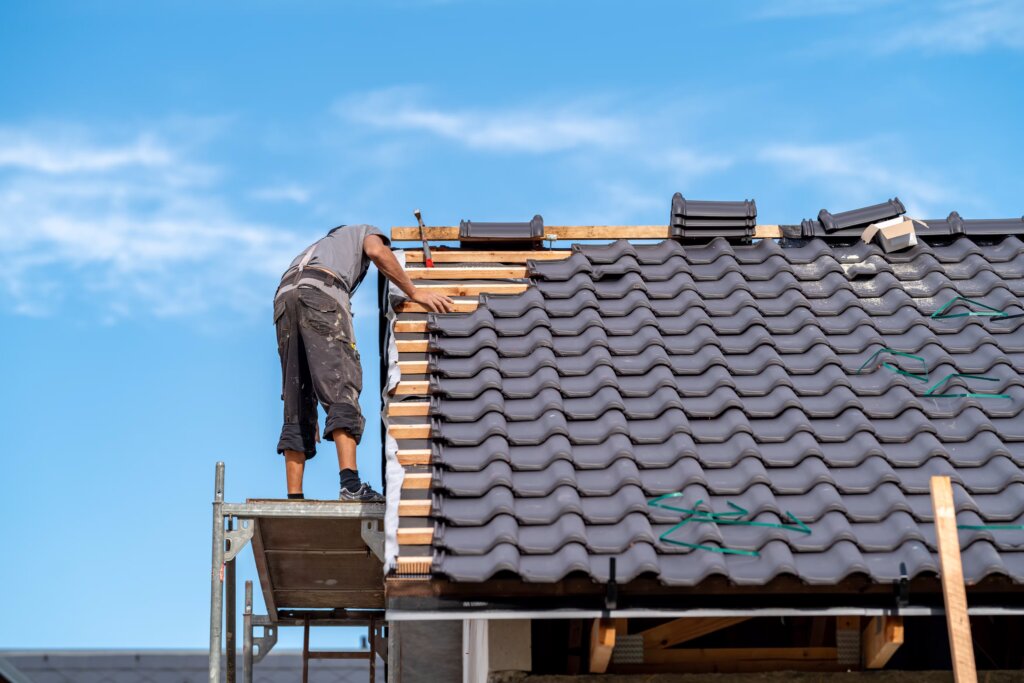 builder-on-the-roof-of-a-family-house-building-a-2025-01-09-00-26-31-utc