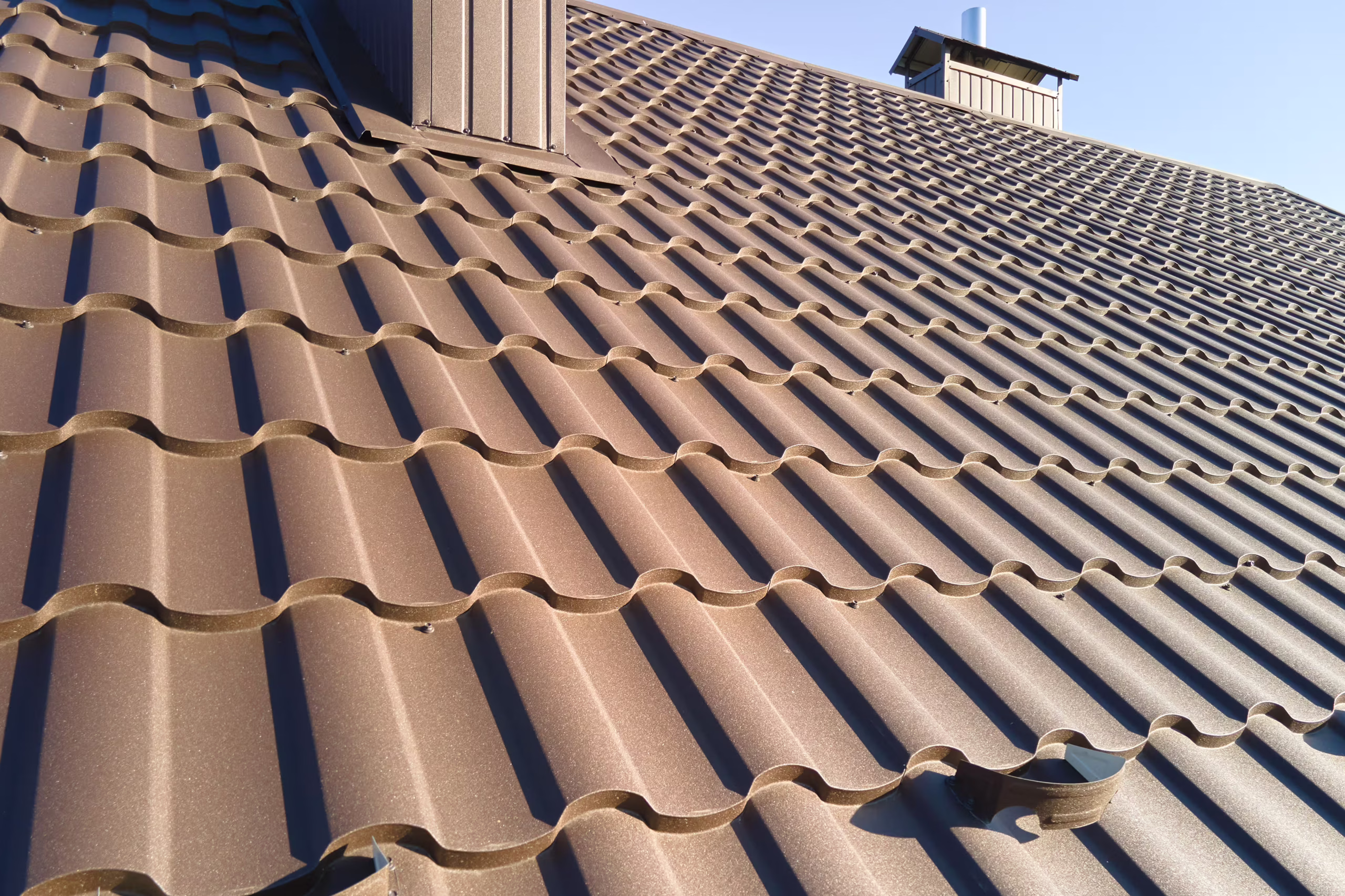 closeup-of-house-roof-top-covered-with-metallic-sh-2024-12-06-20-53-34-utc closeup-of-house-roof-top-covered-with-metallic-sh-2024-12-06-20-53-34-utc