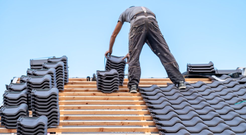 a-craftsman-installs-a-fired-ceramic-tile-on-the-r-2025-01-09-01-07-42-utc